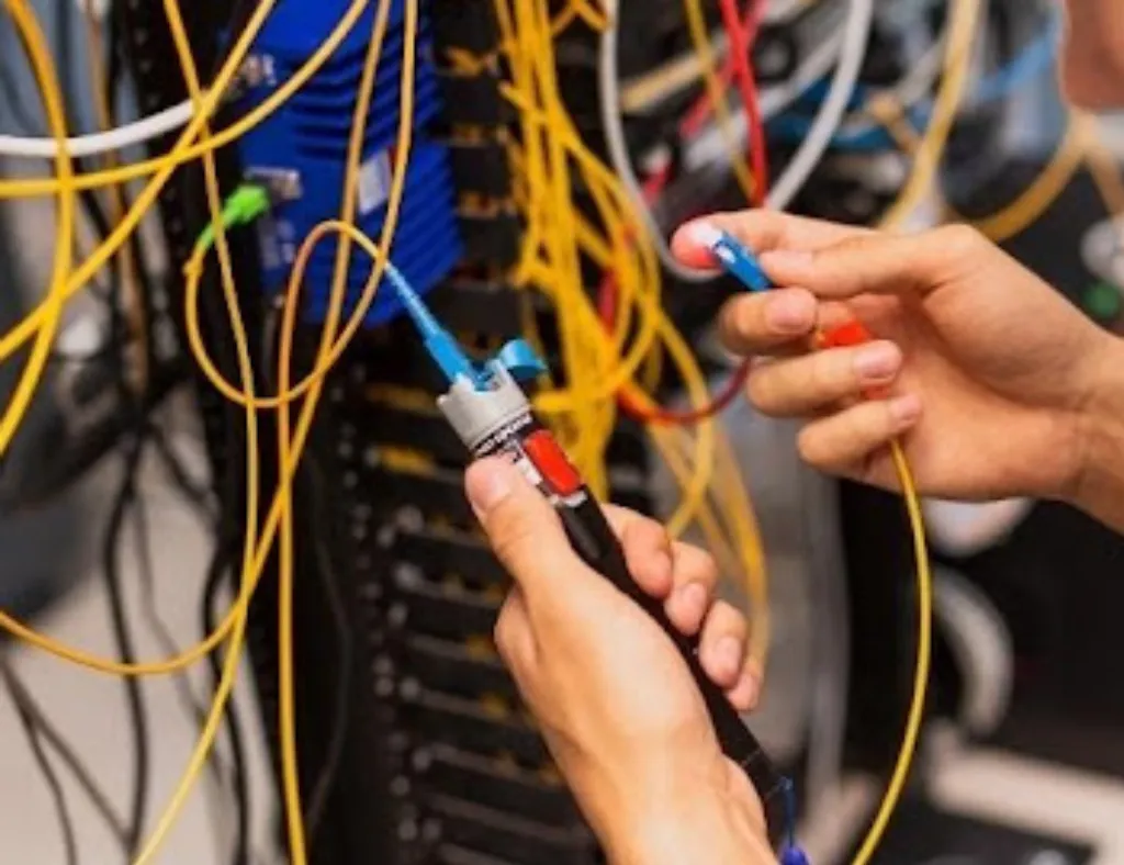 Queda de Tensão em Instalações Elétricas: Como Evitar | ViaCabos 2 Técnico realizando teste em cabos de rede e infraestrutura de telecomunicações